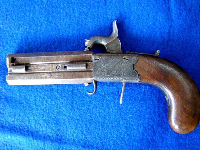 An English .40 cal. percussion pocket pistol with swivel over and under barrells by Wood & Son, York, circa 1850